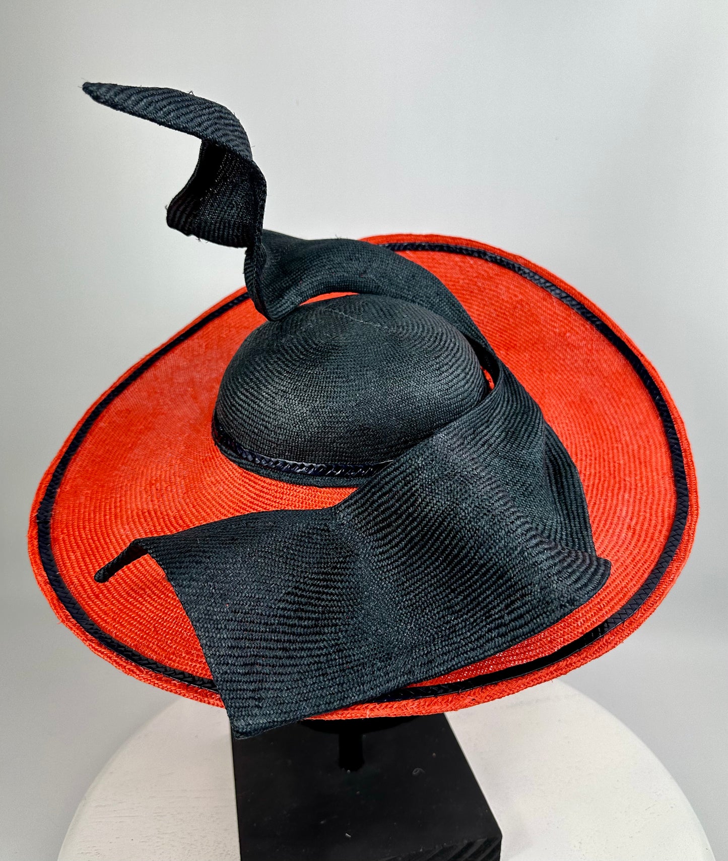 Orange hat with a black bow on a white background