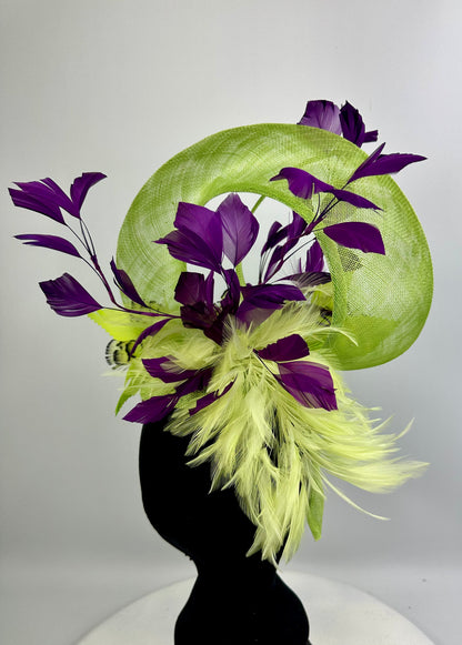 Fluro Green decorative headpiece hat with deep purple leaves and feathers on a white background
