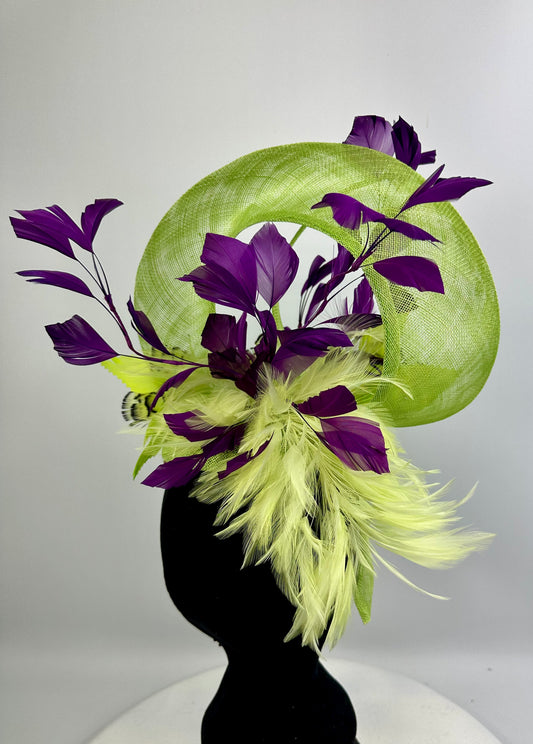 Fluro Green decorative headpiece hat with deep purple leaves and feathers on a white background