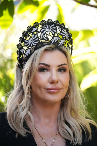 Blonde woman wearing black and white lace crown with embroidery, trimming for special occassions and race day fashions on the field
